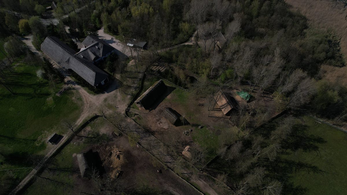Aerial shot of the historic Bronze Age village Biskupin, nestled in Poland's rural landscape.
